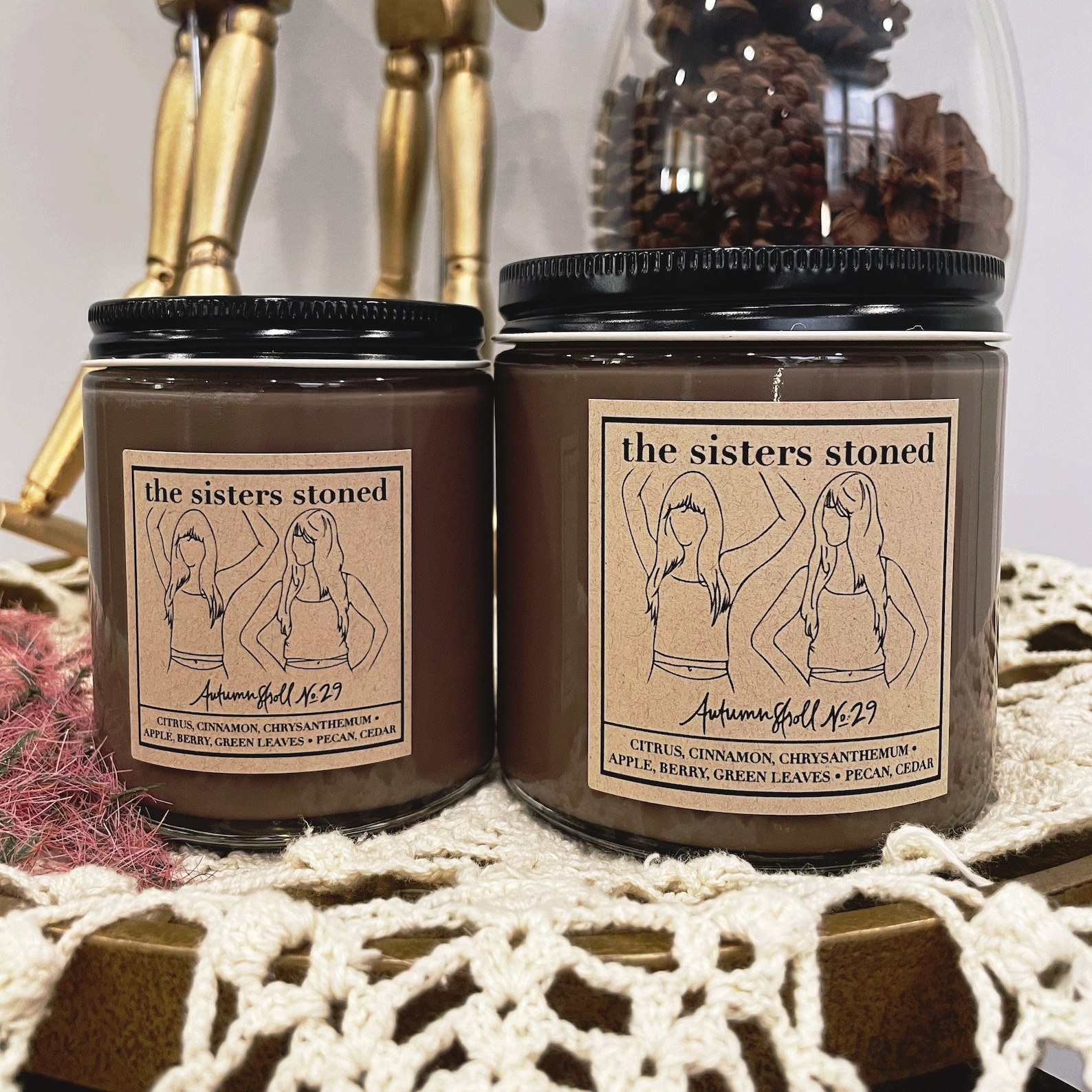 two brown candles with a brown paper label on them that says &quot;Autumn stroll no 29&quot;