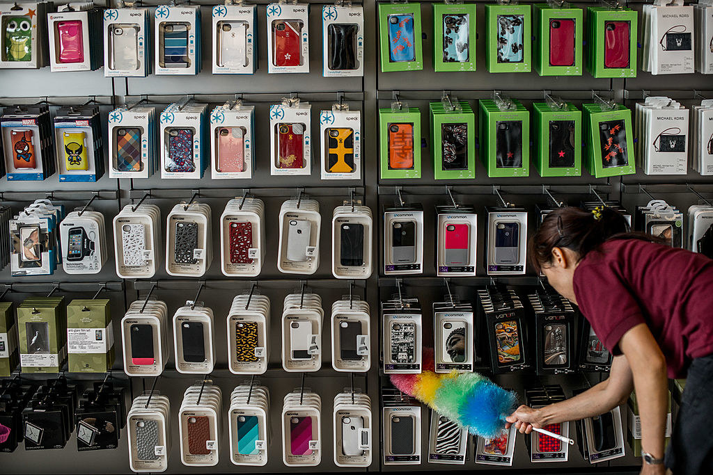 A woman cleans a selection of cell phone covers