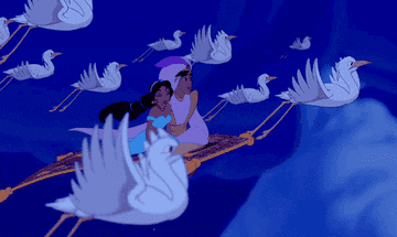 Aladdin and Jasmine flying through the air on the magic carpet surrounded by birds