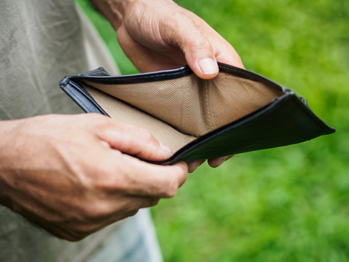 A man opening an empty wallet