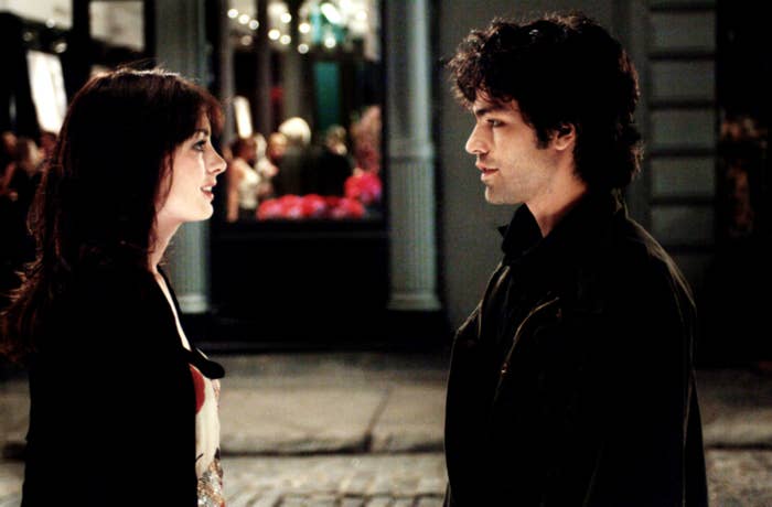 Nate and Andy look serious while standing in the street and talking
