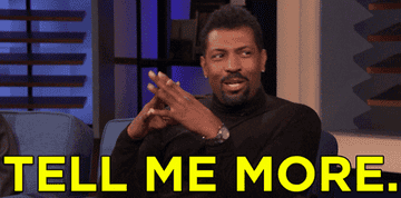 Gif of Deon Cole on Conan clapping his hands and saying &quot;tell me more&quot;