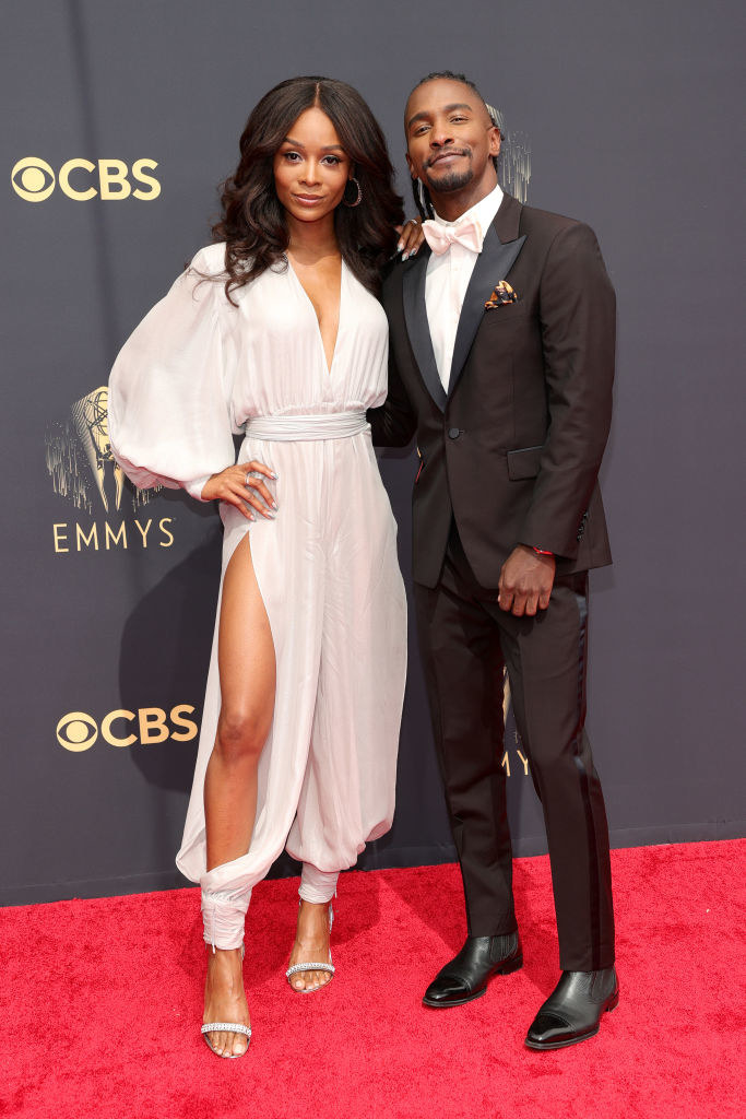 Zuri Hall wears a light colored jump suit and Scott Evans wears a dark suit