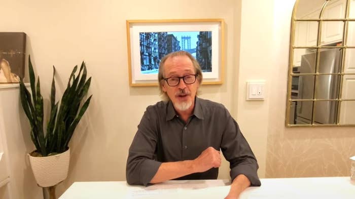 Steve sitting down at a table and speaking to a camera