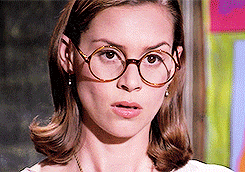 Gif of Miss Honey in the movie Matilda moving her glasses down her nose and looking awestruck