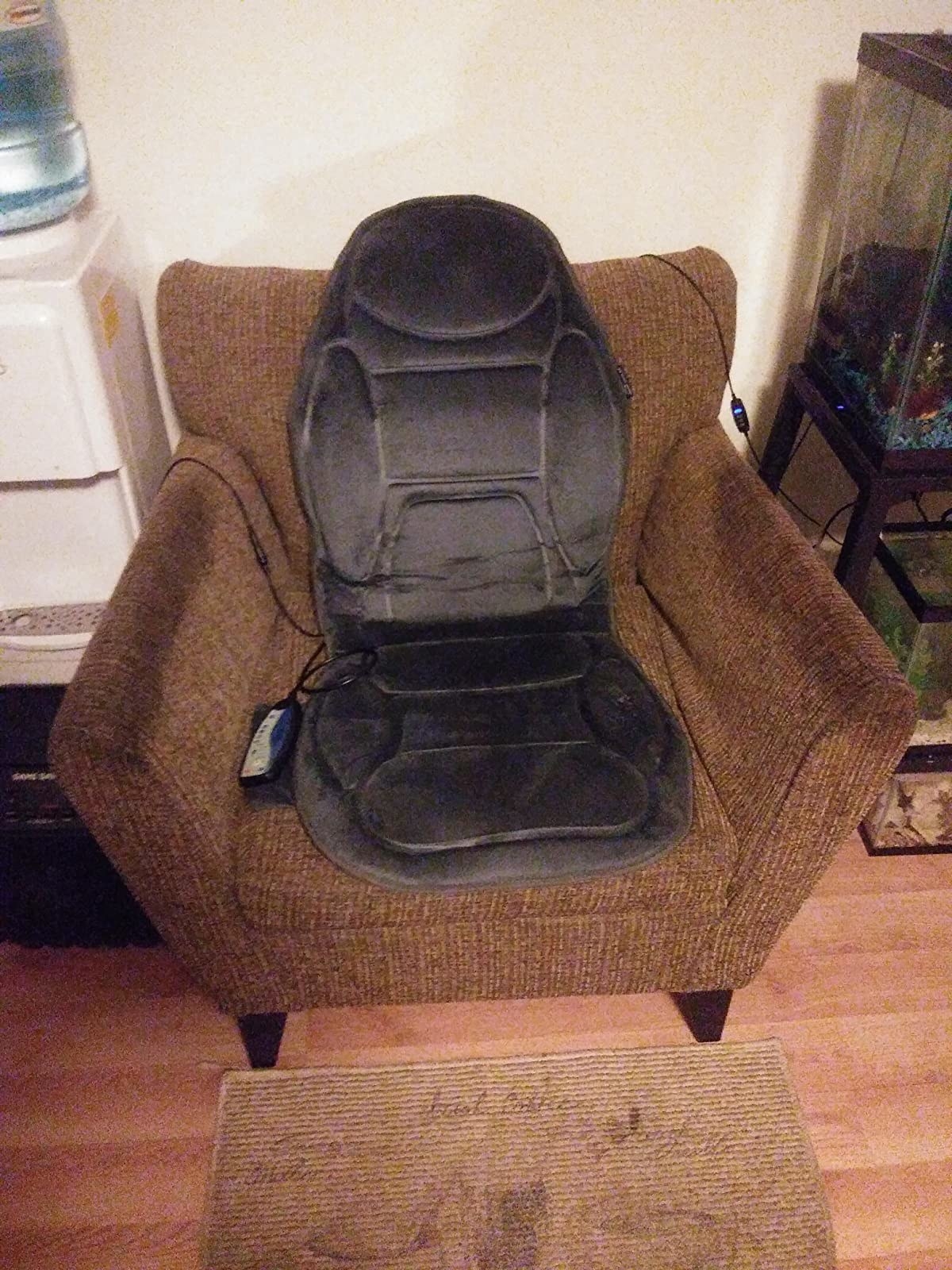 A reviewer's armchair with the massage cushion with remote control