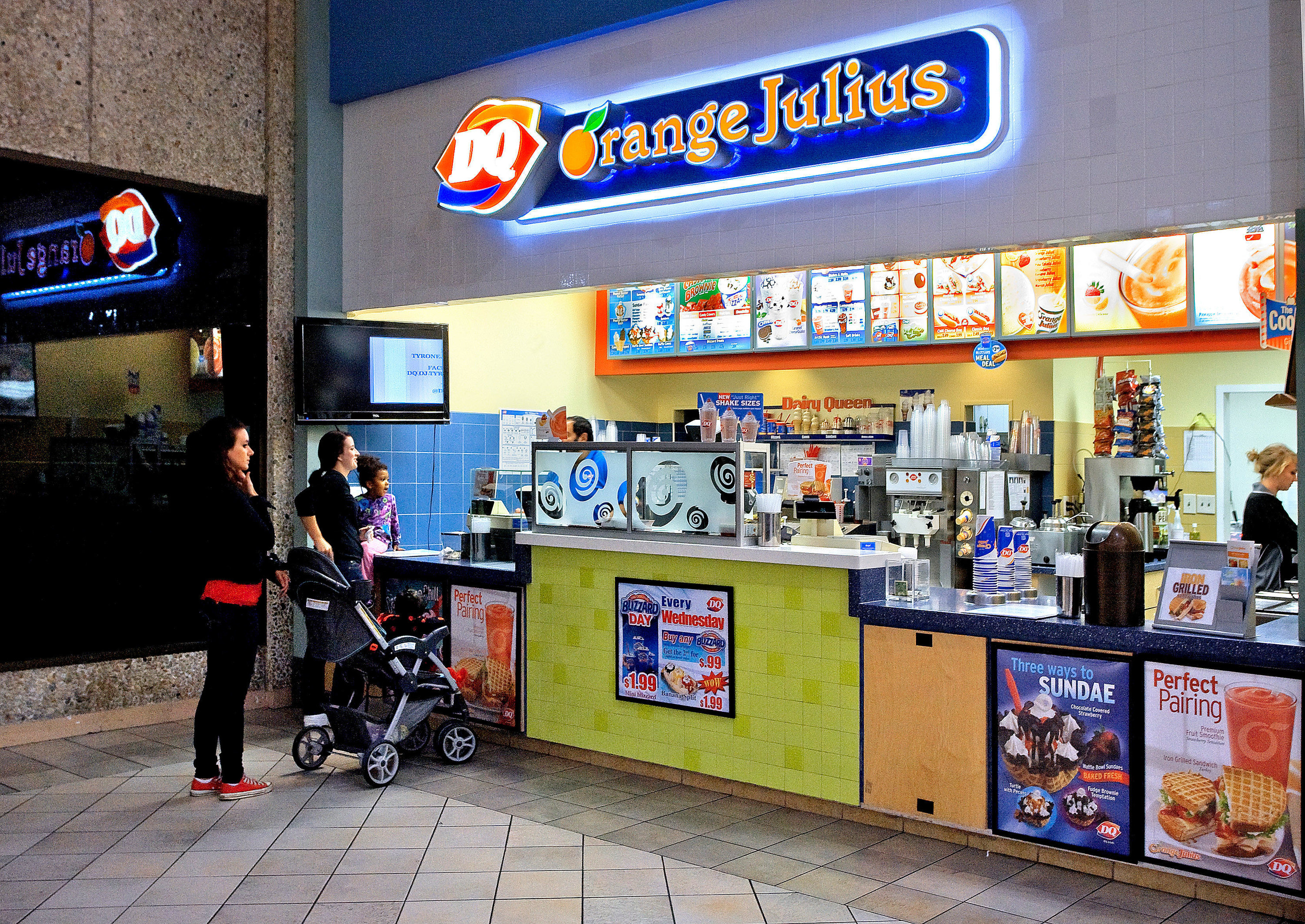 an orange julius stand in a mall
