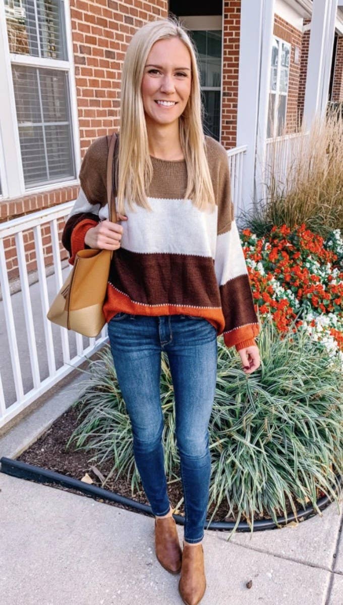 a pullover sweater with brown orange beige and white stripes
