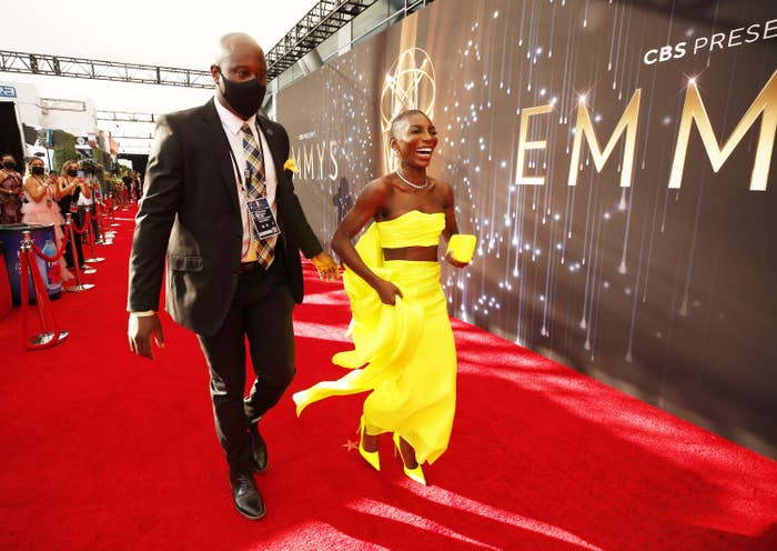 Michaela walking on the red carpet and smiling