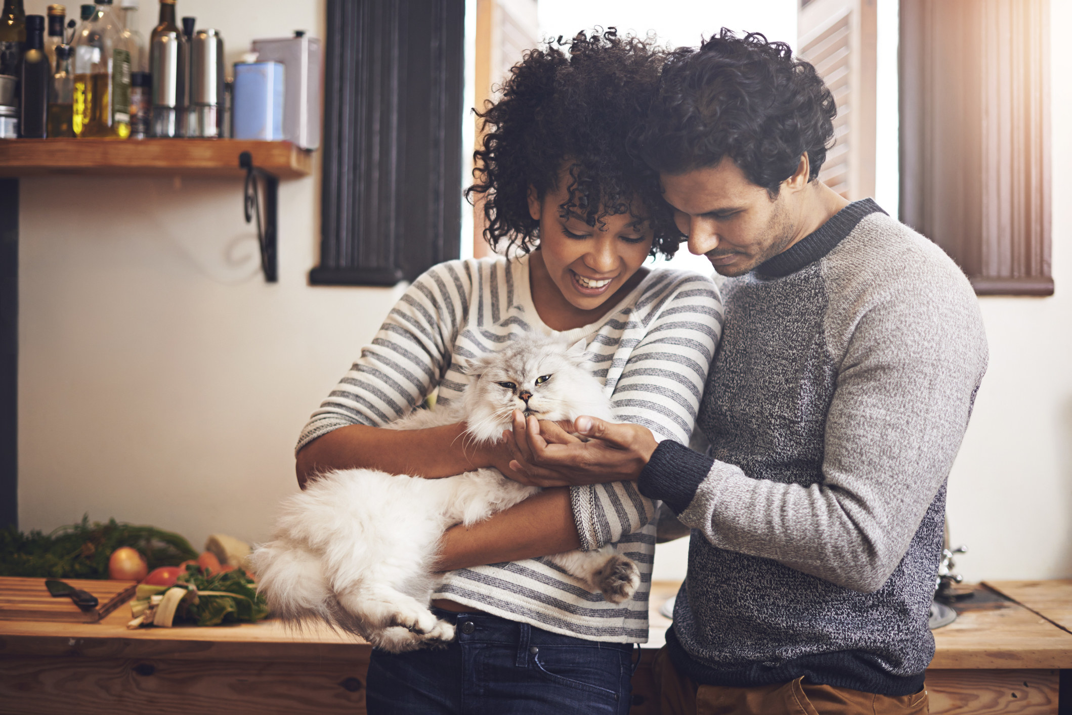 Couple with their cat at home
