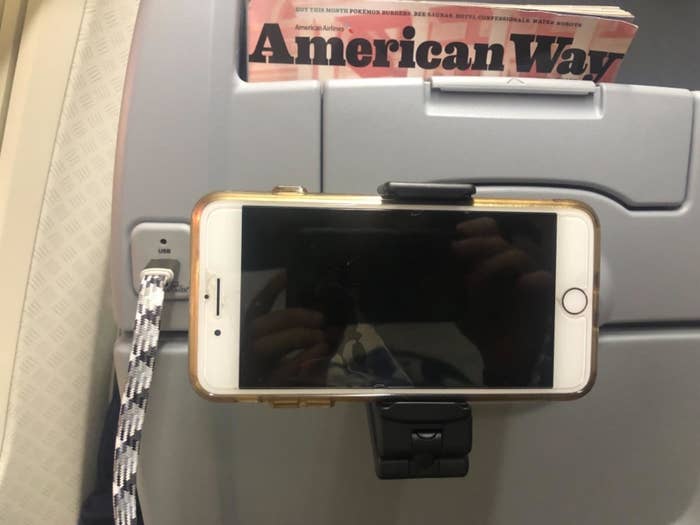reviewer image of an iPhone in an airplane phone mount on a plane