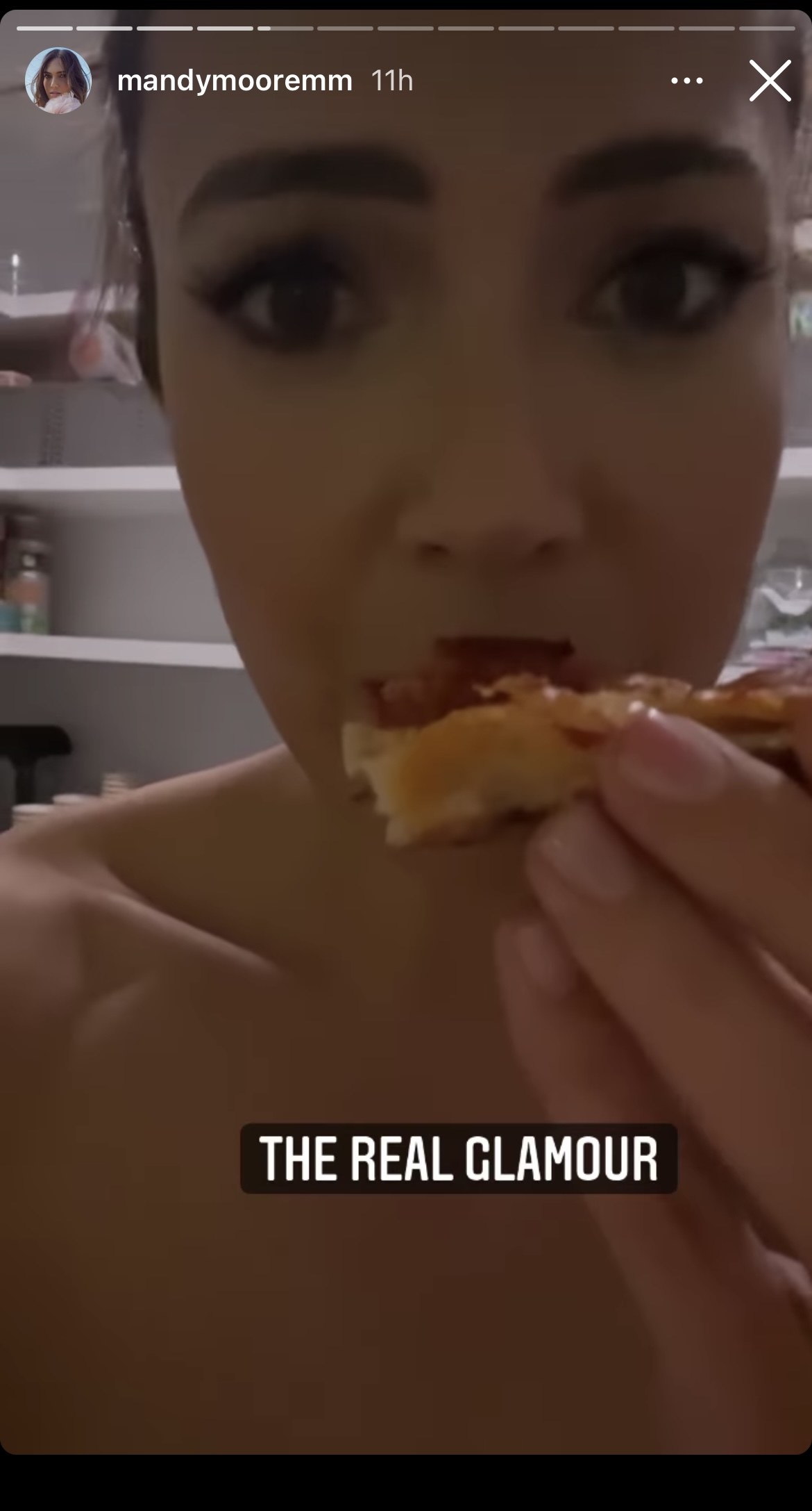 Mandy eating pizza with the caption &quot;The real glamour&quot;