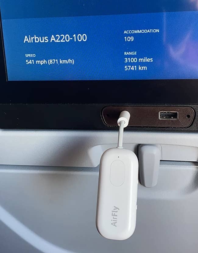 the small device plugged into an airplane headphone port