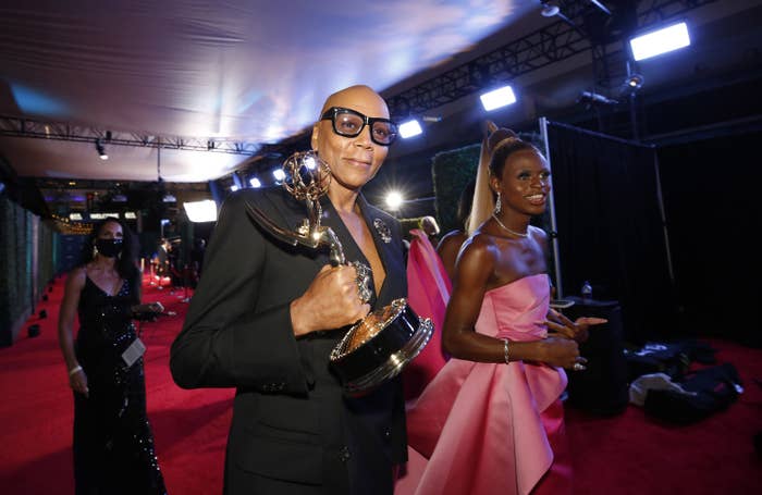 RuPaul walking with his Emmy Award
