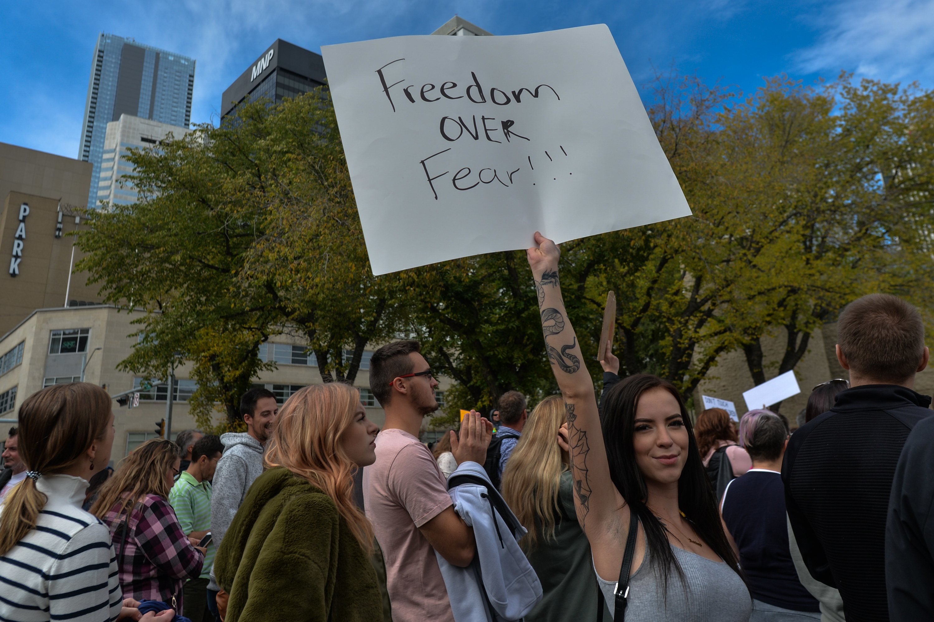 One person holding up a sign that says &#x27;Freedom over fear!!!&quot;