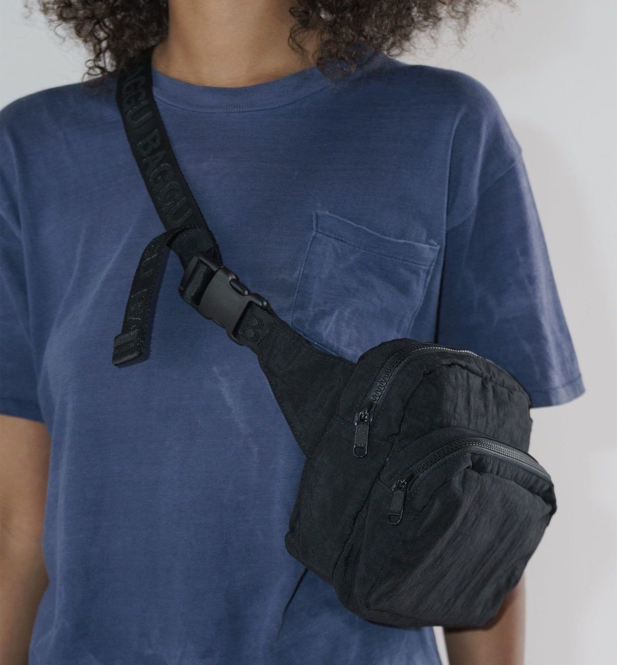A person wearing the fanny pack crossbody style