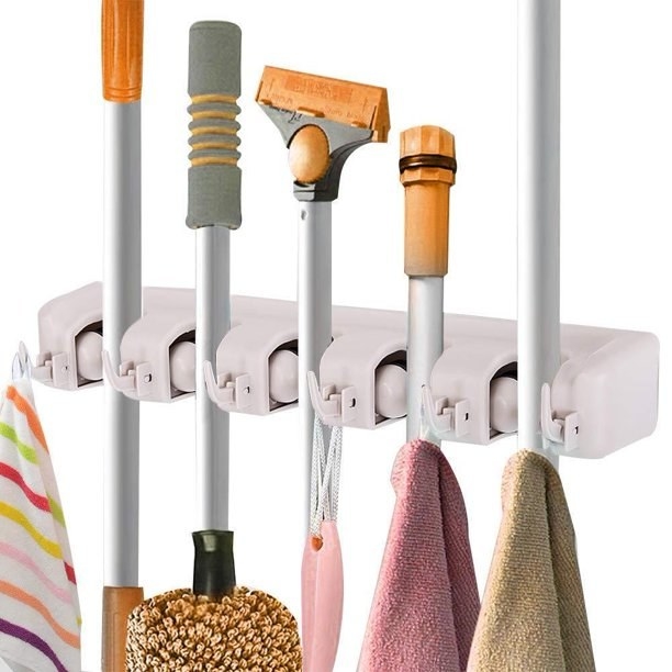 Hanger shown holding cleaning tools and towels.