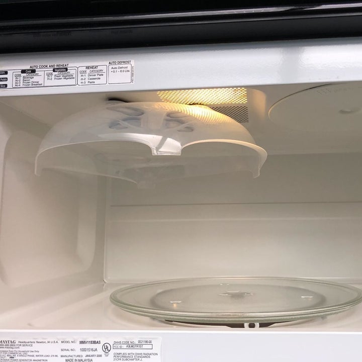 a reviewer photo of the cover sticking to the top of the microwave 