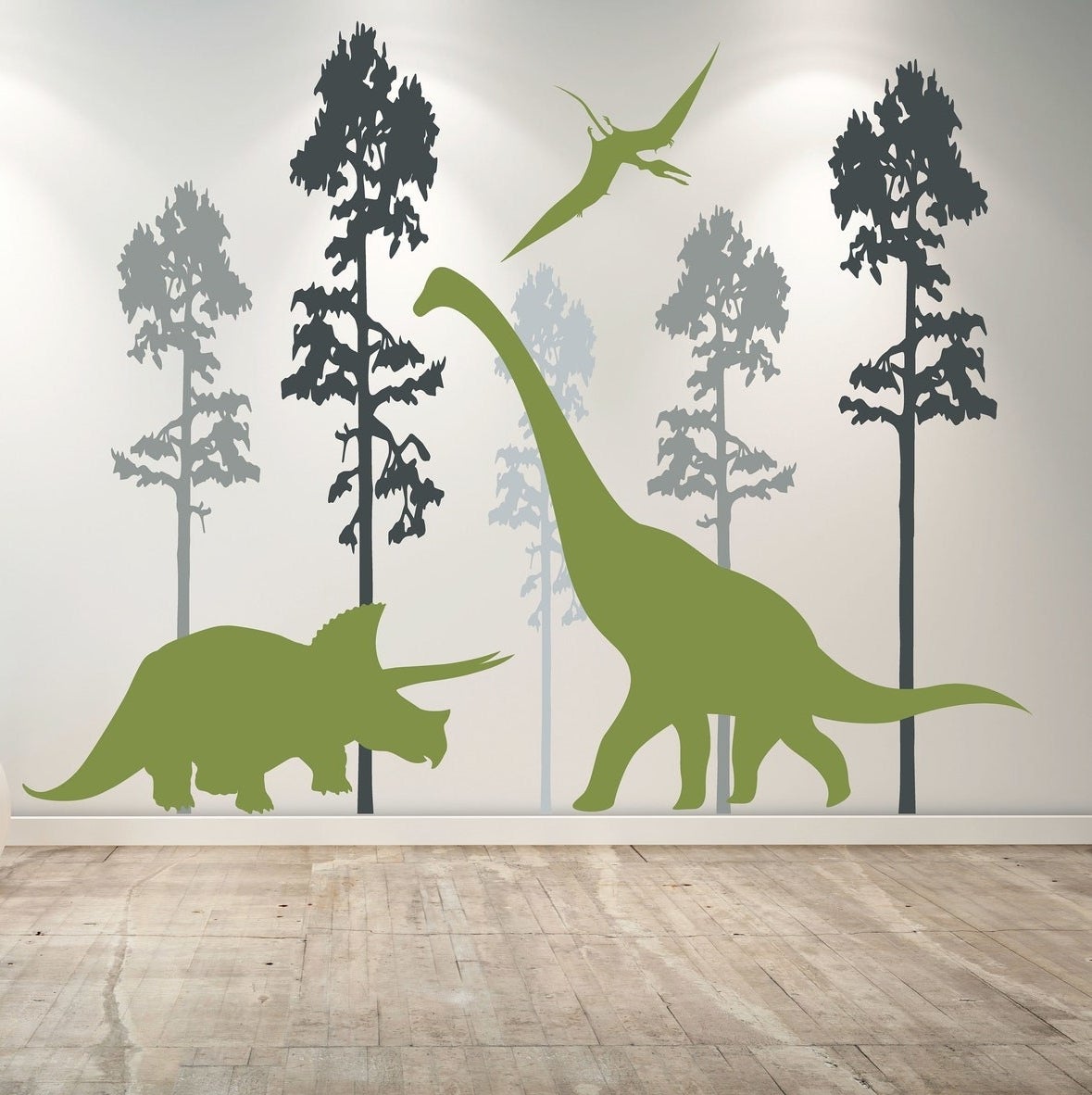 Three green dinosaur wall decals with trees in various shades of blue