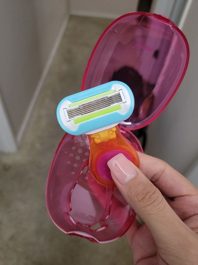 A model holding a mini razor with a matching protective case