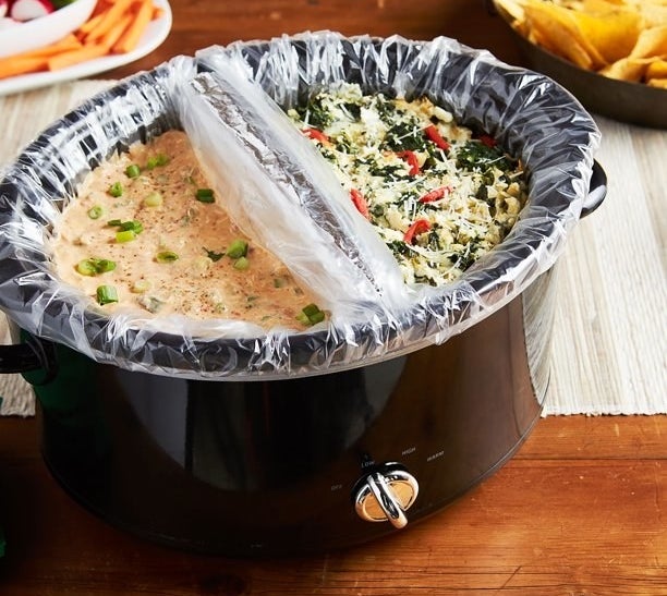 a slow cooker with two liners inside each filled with a different dish