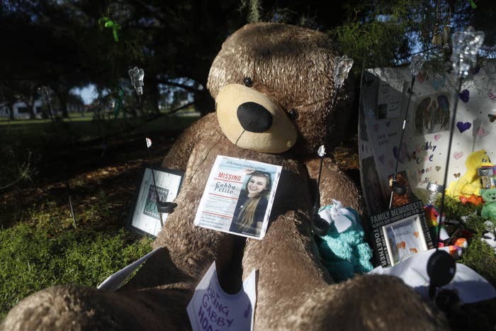 A large stuffed Teddy bear and other tributes to Gabby are laid out