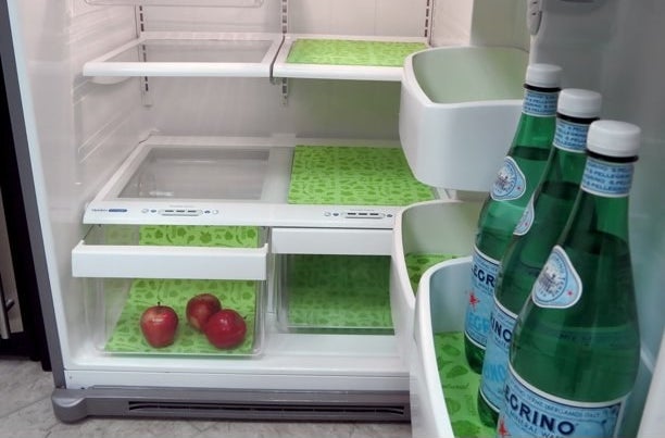 a fridge with the liners on various shelves