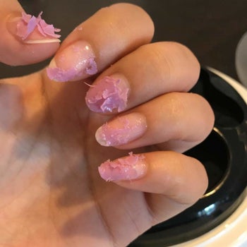 Model with gel on their nails falling apart after being in the machine 
