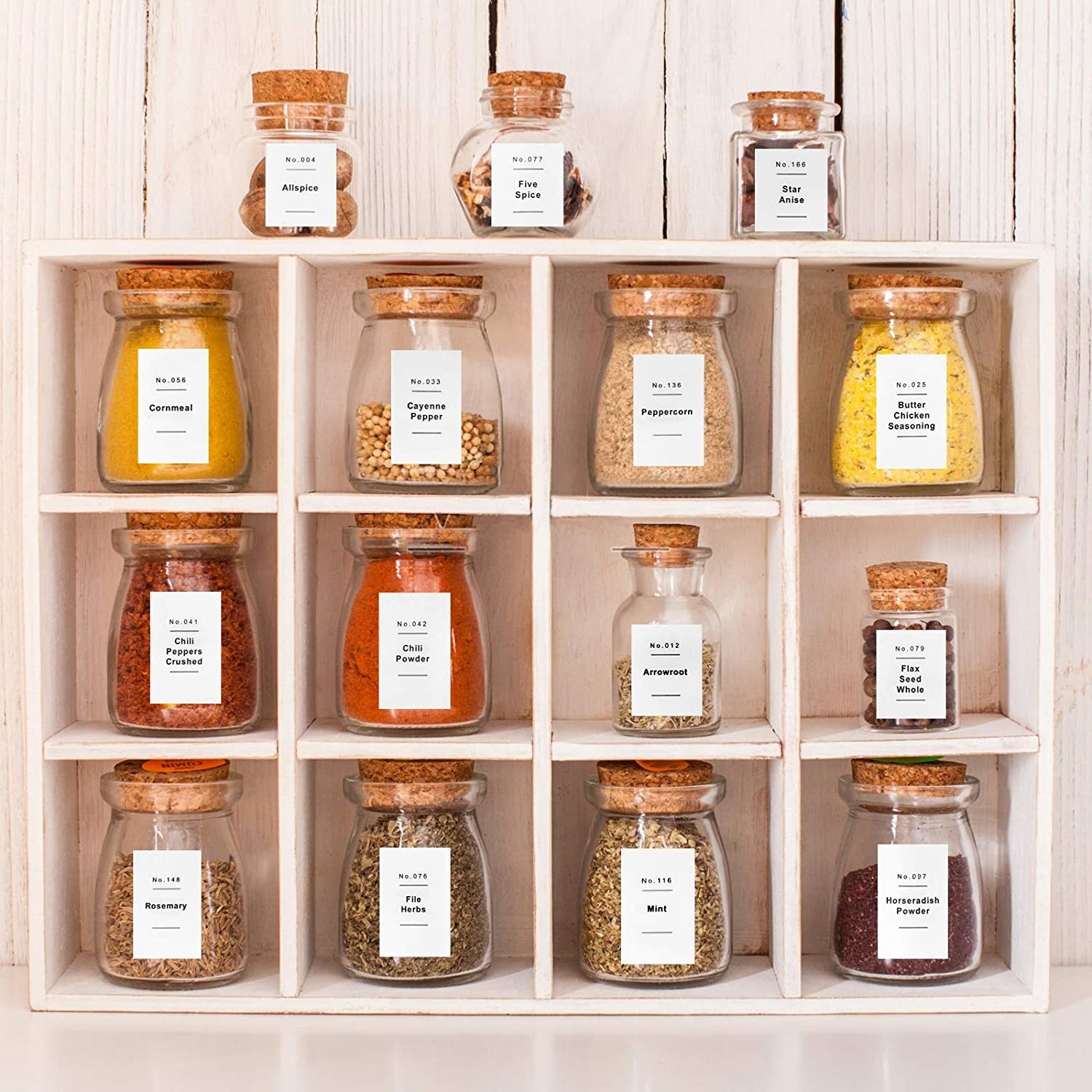 a neat spice shelf containing jars of spices; all are neatly labelled