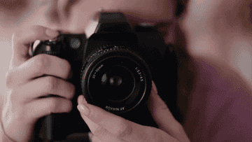 woman taking photos on camera