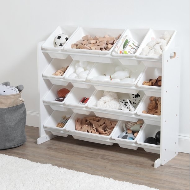White storage unit with 16 plastic bins holding various toys.