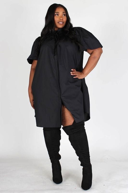 model with short sleeve and button down black dress and knee high boots