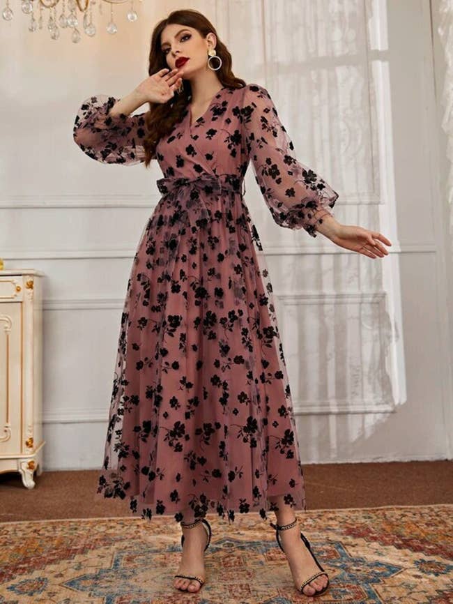 model in ankle length long sleeve dress with a floral overlay
