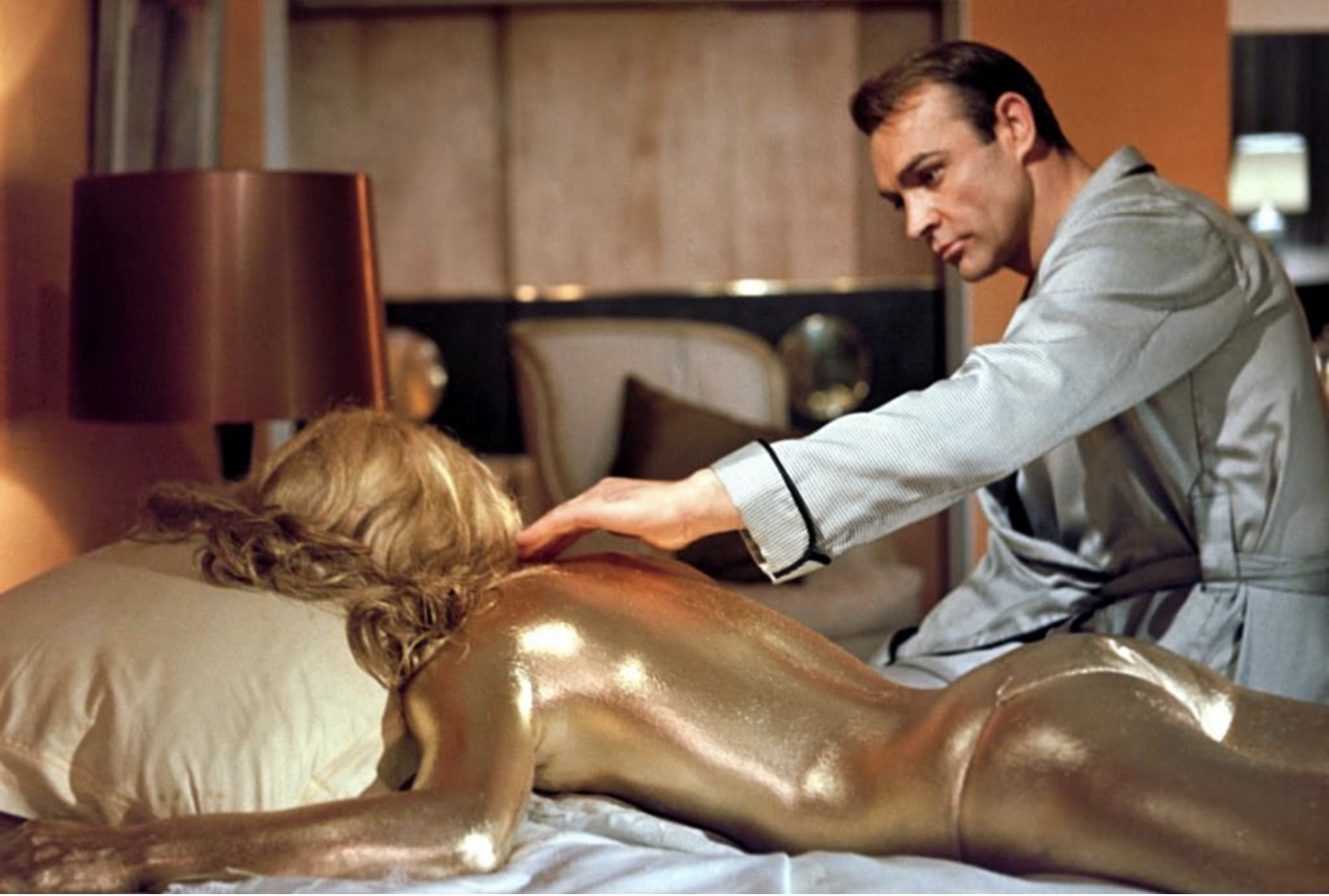 Bond touches the bikini-clad, gold-covered body of Shirley Eaton