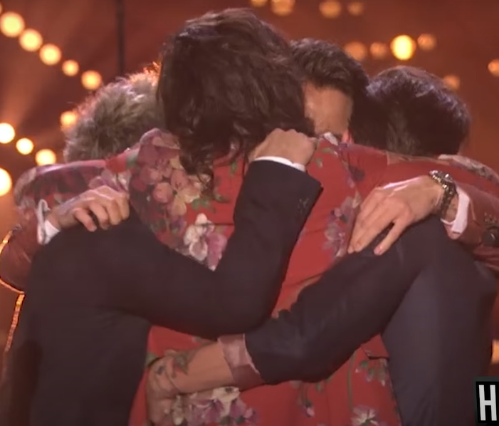 A bunch of men group hugging