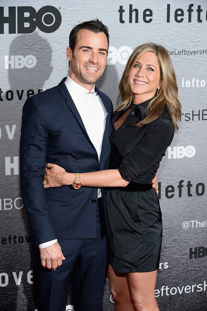 Justin Theroux (L) and Jennifer Aniston with their arms around each other at &quot;The Leftovers&quot; premiere