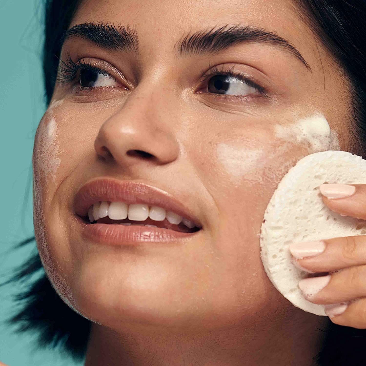 model using the cleansing bar on their face