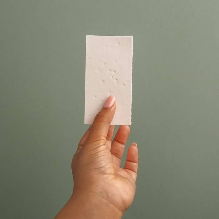 A person holding a detergent strip