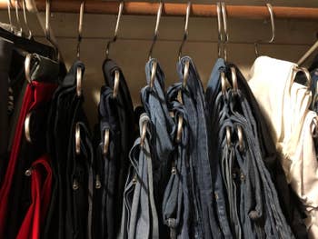multiple pairs of jeans hanging from the S-shaped hangers looking much neater in the closet