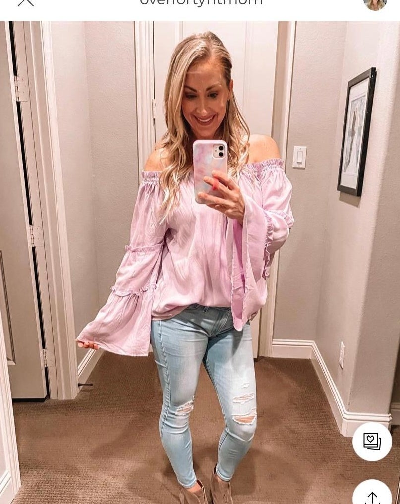 Reviewer wearing pink top with flowy sleeves, stop past the waist