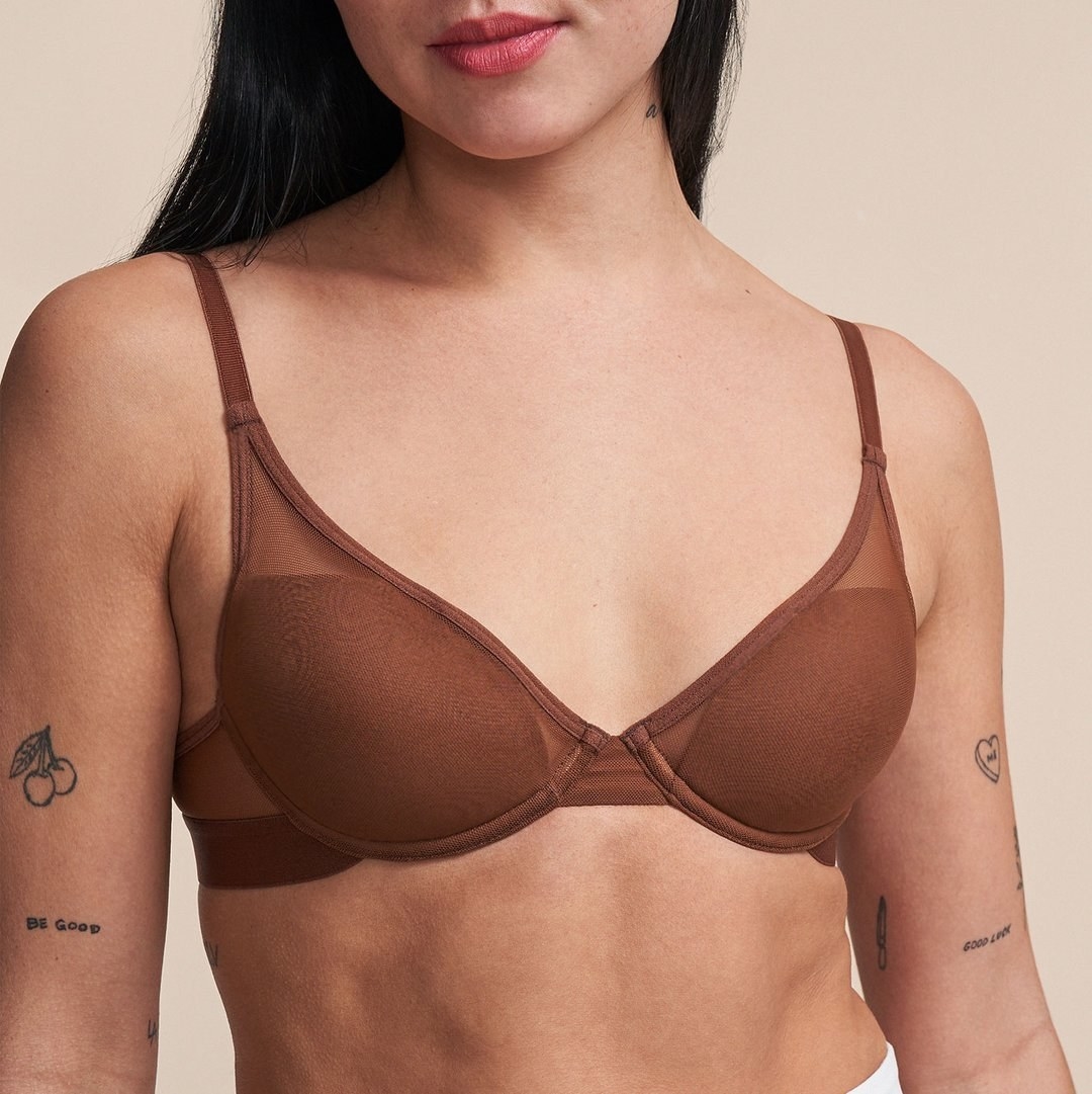 model with tattoos wearing brown pepper bra