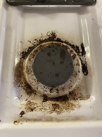 reviewer photo showing their gas burning covered in burnt food and grease