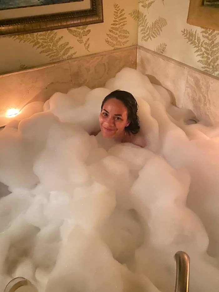 reviewer in bathtub, up to her neck in bubbles
