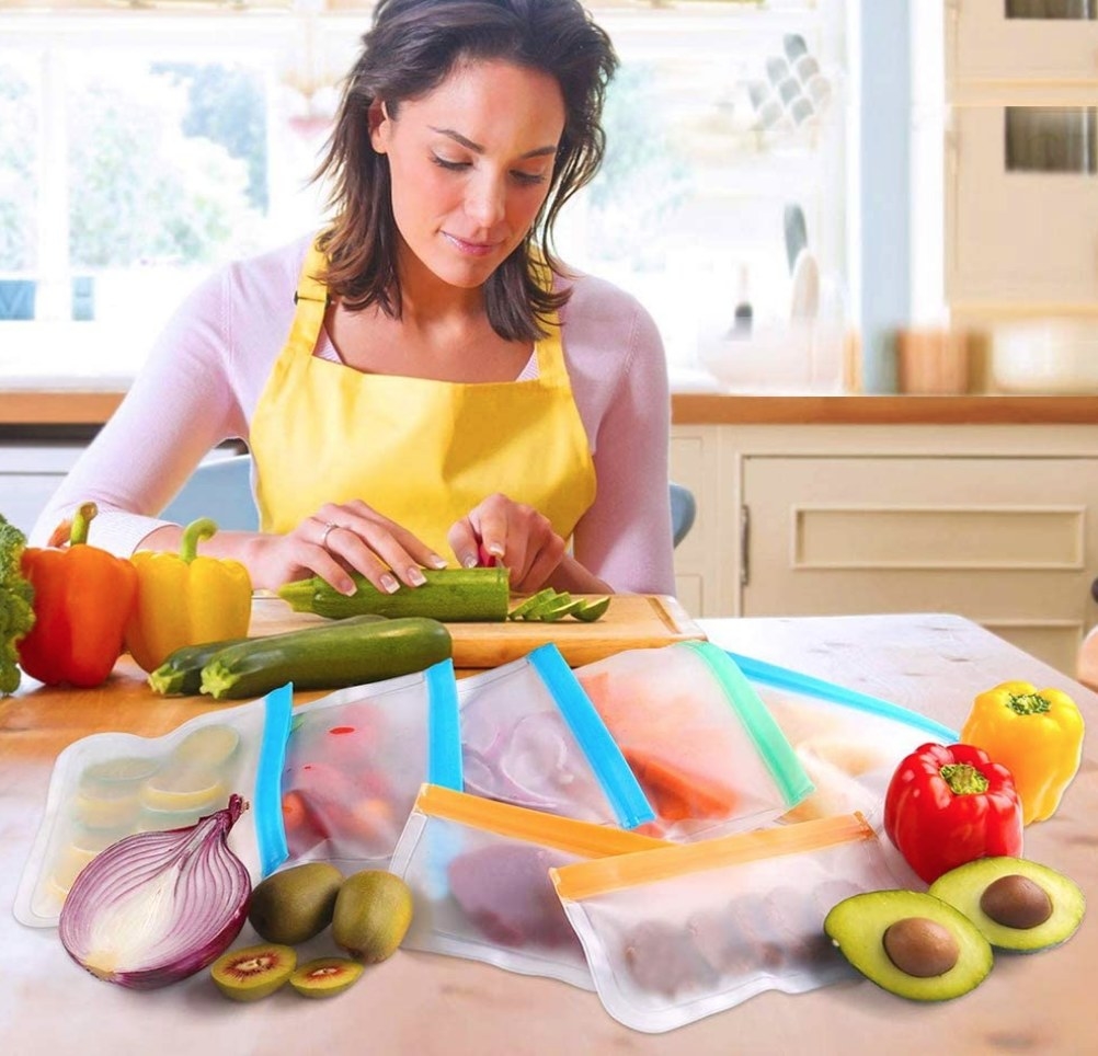 A model cutting up vegetables to place inside reusable sandwich bags