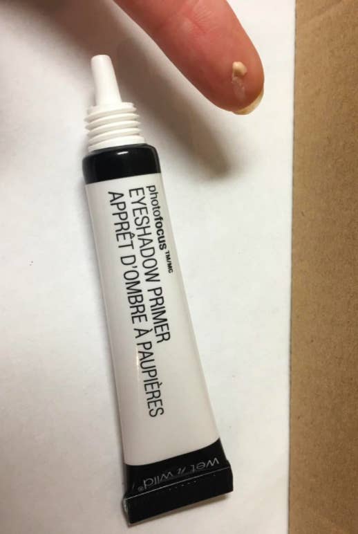 the tube of primer and a reviewer's finger showing the primer on their fingertip