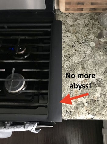 a reviewer of the same stove with a gap filler installed and text reading 