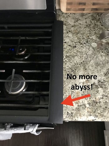 a reviewer of the same stove with a gap filler installed and text reading