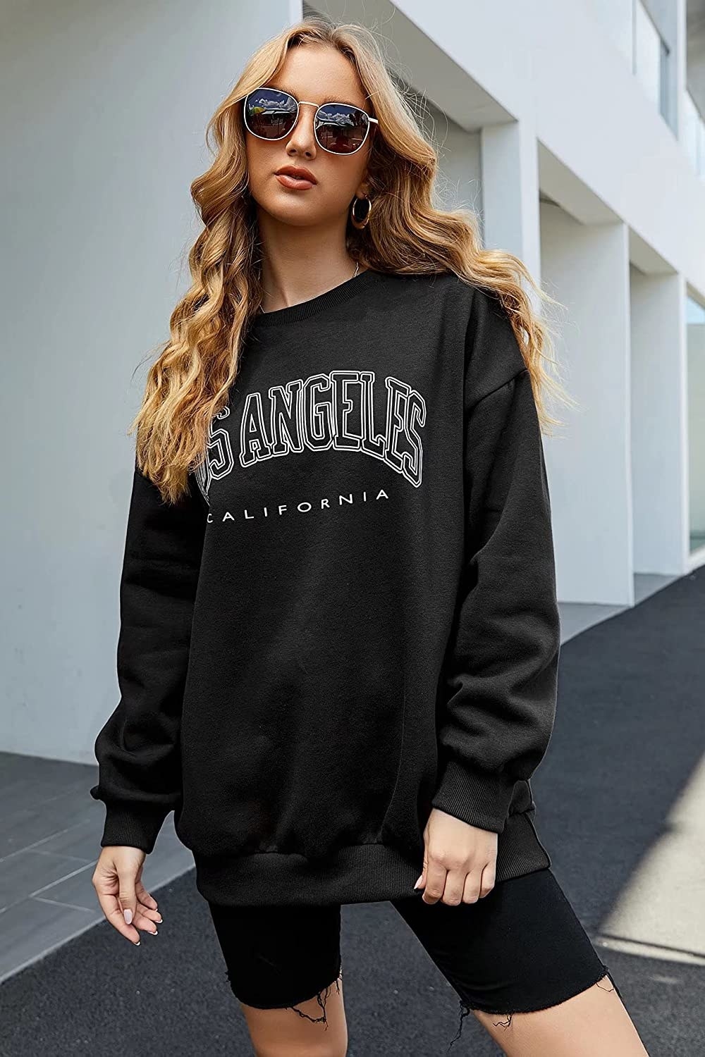 model wearing the los angeles sweatshirt outside