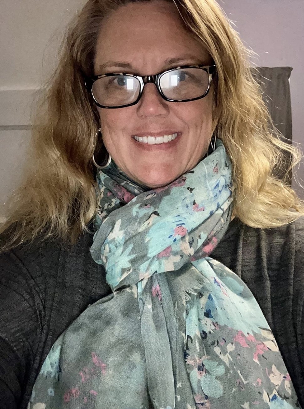 a reviewer wearing the shawl in grey
