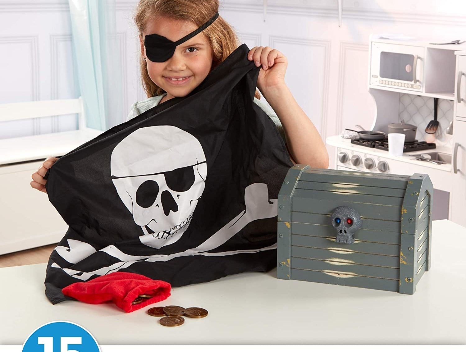 Child model holding pirate flag with toy chest and coins
